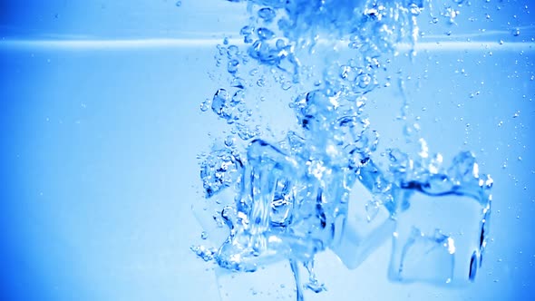 Ice Cubes Dropped Into Water with Air Bubbles