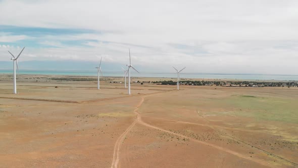 Aerial View of Wind Turbines Near the Lake