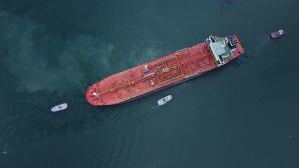 Aerial View of Tanker Ship with Escorting Tug Leaving Port