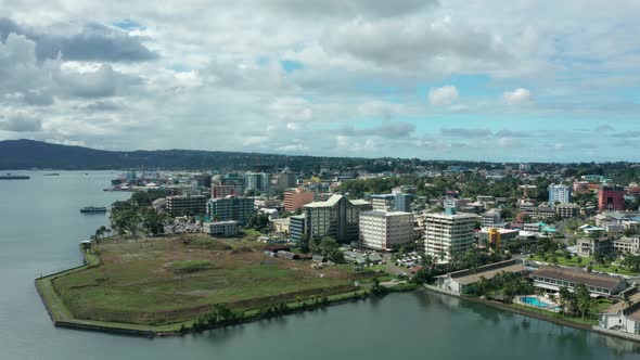 Hotels and resorts on coast of capital Suva in Fiji, aerial shot, pan right