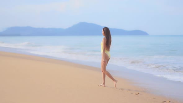 Asian woman enjoy around beautiful beach sea ocean