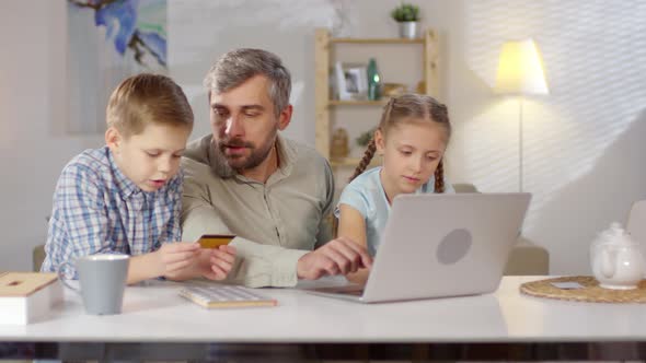 Father and Two Children Shopping Online