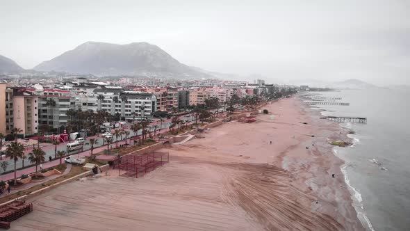 Vehicle cleaning sandy beach before summer beach season.