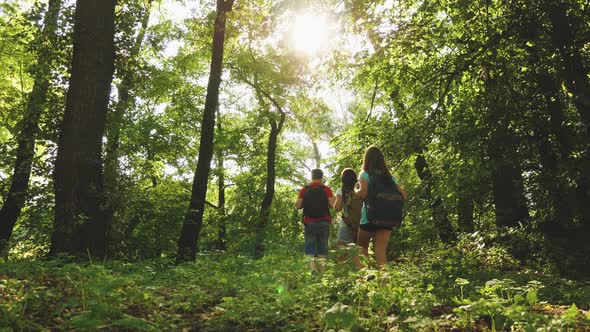 Dad and Daughters, Children Travel in Park in Summer. Teamwork Travelers. Family on Vacation Travels