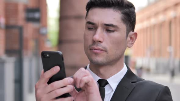 Outdoor Businessman Using Smartphone Typing Message