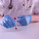 Doctor is showing test-tube with positive Coronavirus blood test. Covid-2019 world pandemic - VideoHive Item for Sale