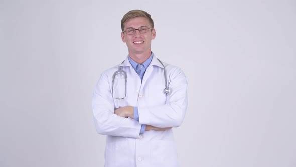 Happy Young Handsome Man Doctor Wearing Eyeglasses with Arms Crossed