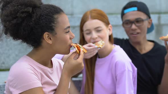 Biracial Girl Eating Tasty Pizza With Best Friends Outdoor, Fast Food Snack