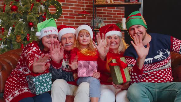 Man Sets Timer on Mobile Phone Taking Multigenerational Family Selfie Portrait Celebrating Christmas