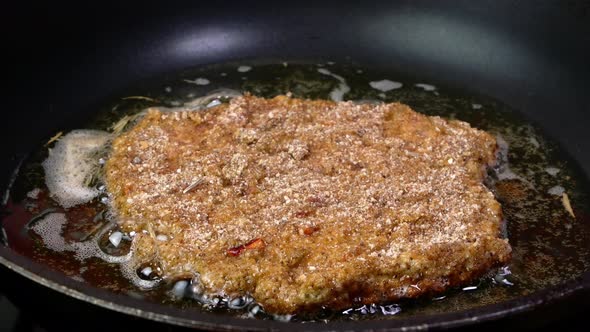 Meat Chop Cutlets in Breadcrumbs with Crispy Crust Fried in Vegetable Oil in Frying Pan