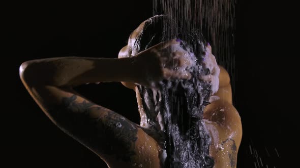 Wet Brunette Washes Off the Foam From Her Hair While Standing Under a Stream of Warm Shower in Slow