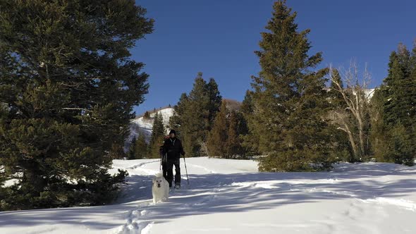 Flying low past couple hiking in the snow