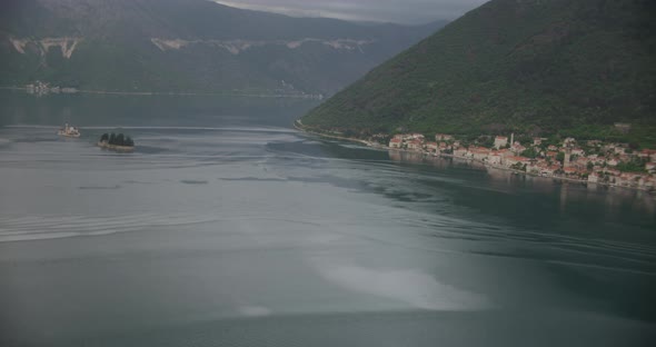 Helicopter aerial pan of beachside cliffs, overcast day