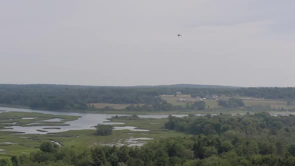 Drone shot of small Cessna plane flying over Scarborough Marsh in Maine.