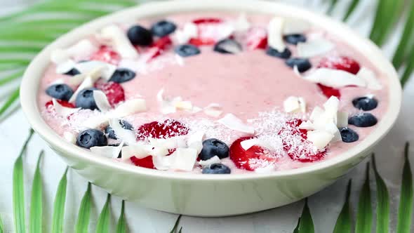 Berry smoothie bowl with strawberries, blueberries and coconut. 