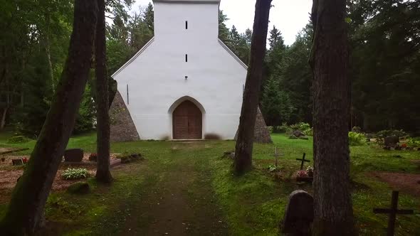 Cemetery in the forest with traditional Chapel in Estonia.