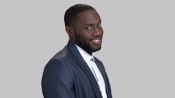 Joyful Afro-american Businessman on Grey Background.