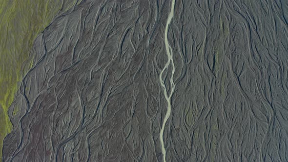 Drone Over Sunlit Landscape With Dry Riverbed Of Braided River