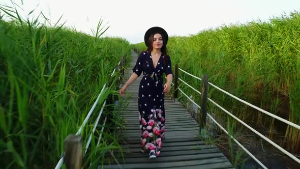 Young Woman Walking In The Reeds