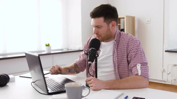 Happy Young Man with Laptop and Microphone at Home 53