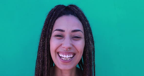 Mixed race girl looking on camera with green background