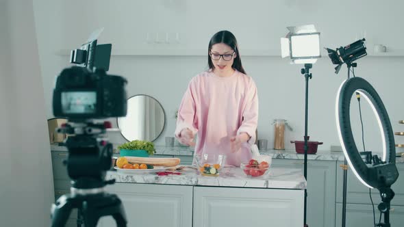 A Woman is Cooking in the Video Studio While Filming