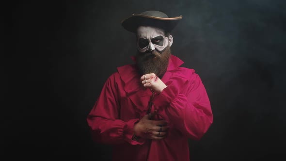Man Dressed Up Like a Scary Pirate in Red Shirt and with a Hat