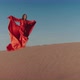 An Asian Woman in a Red Dress Dancing on Sand Dunes - VideoHive Item for Sale
