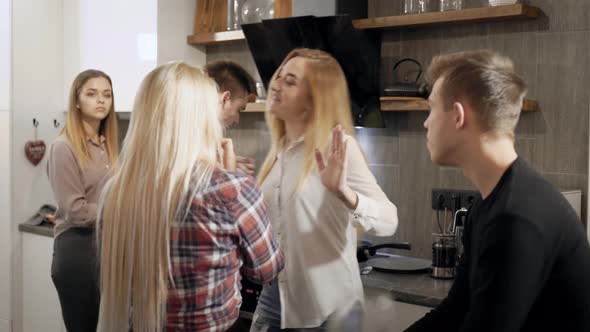 Joyful Female and Male Students Are Chatting on a Kitchen During Home Party