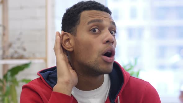 Young Handsome AfroAmerican Man Listening Secret White Background