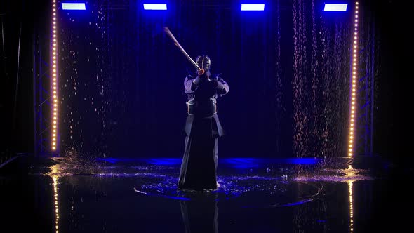 Male Kendo Warrior Dressed in Armor and Traditional Kimono Practices Martial Art with Bamboo Bokken