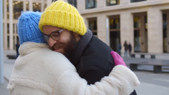 Young Man with Dog Meeting African Girlfriend Outside Airport After Long Separation