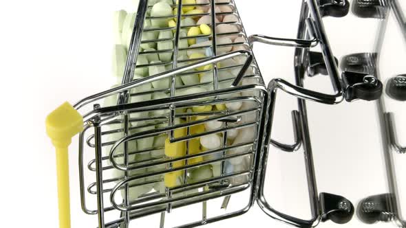 Vertical Video Close Up Shopping Cart with Medicines Rotating Isolated on White Background