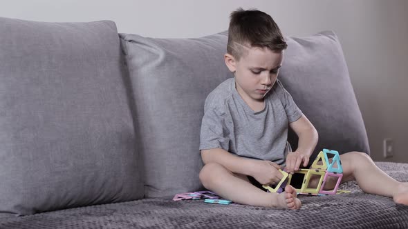A little boy gaming with magnetic constructor. Creativity development. Magnetic constructor.