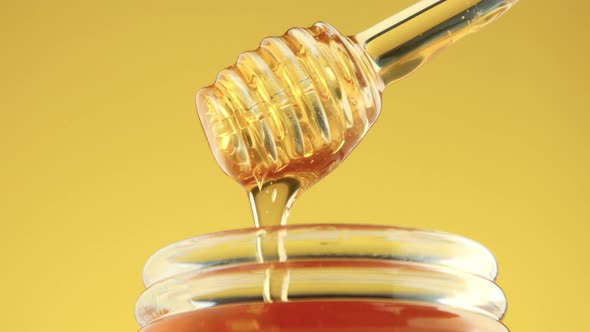 Closeup of Honey Spoon with Pouring Honey