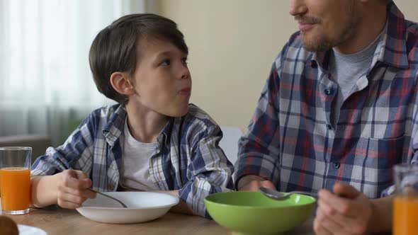 Father and Son Having Breakfast Together, Eating Tasty Cornflakes Morning Home