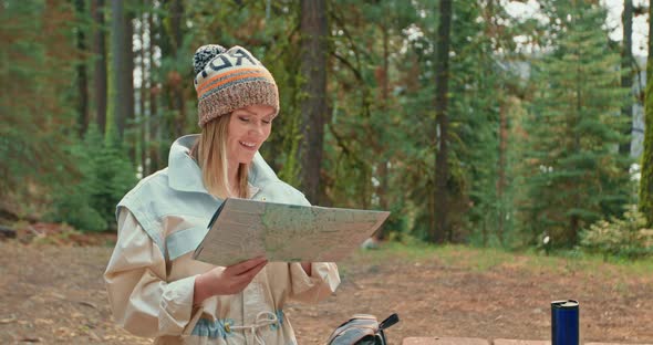 Slow Motion Pretty Smiling Woman in Green Forest. Young Female Exploring Map