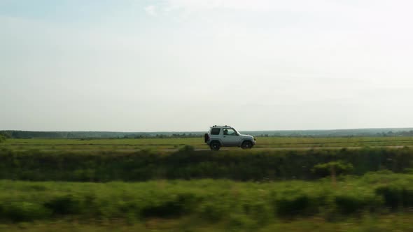 Aerial View of a Car Driving on a Country Road