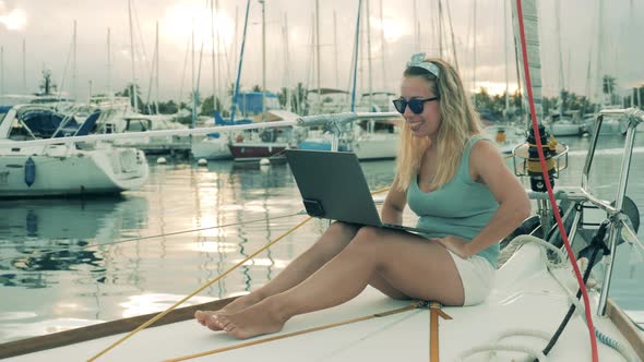 Excited Woman Is Making a Videocall Onboard of a Yacht