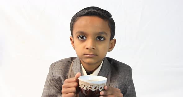 one Pakistani kid drinks a tea.