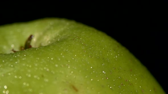 Side of Wet Green Apple Isolated on Black, Rotation Close Up