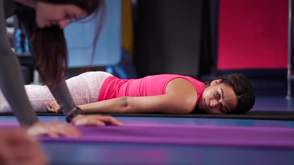 Girls relaxing on mats after training in gym