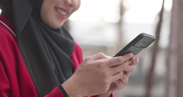 Close up hand Muslim woman chatting on smartphone at outdoor