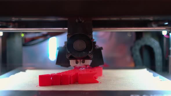 Closeup of 3d Printer is Making a New Red Model Shape