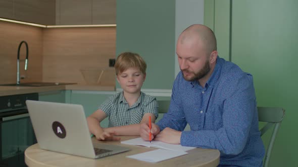 Father and His Son Doing Online Homework