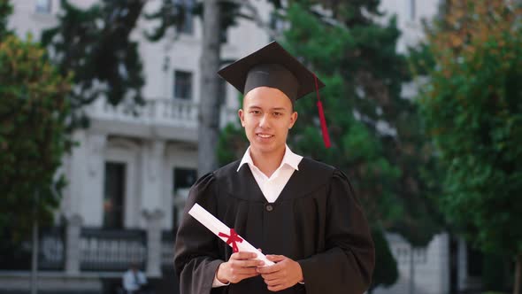 Happy Charismatic Graduate Guy Holding His Diploma