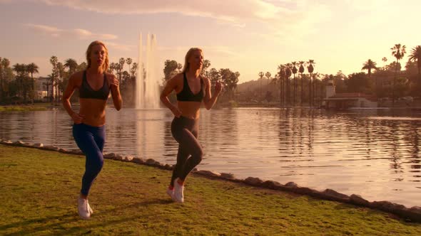 Athletic Twins Running In The Park Slow-Motion