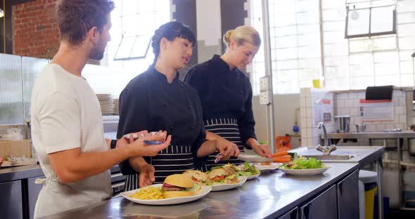 Manager giving order to chef in commercial kitchen 4k