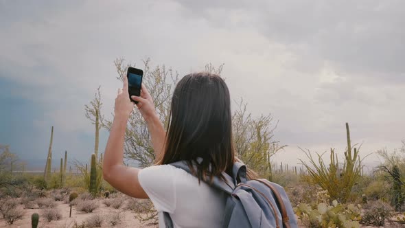 Slow Motion Young Happy Tourist Woman Taking Smartphone Photo of Giant Cactus at Desert