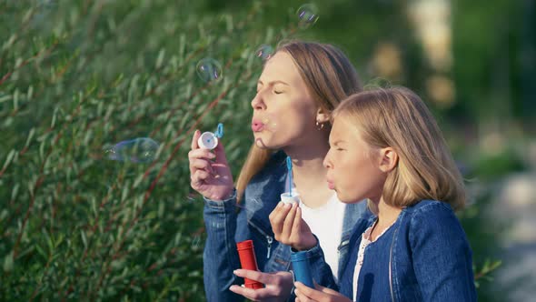 Mom and daughter with soap bubbles